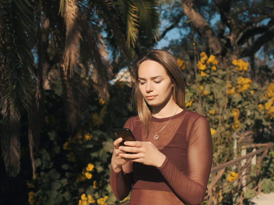 A guest checking their phone for a reply.